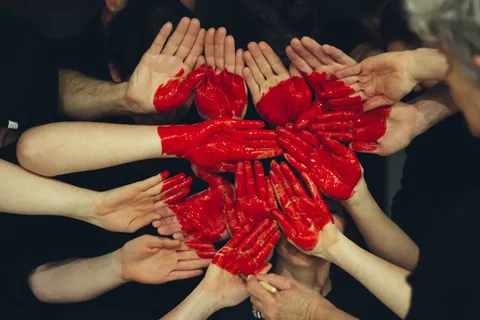 Community members joining hands together